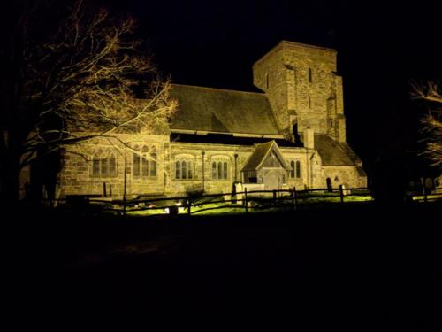 Image of the Church lit up at night.